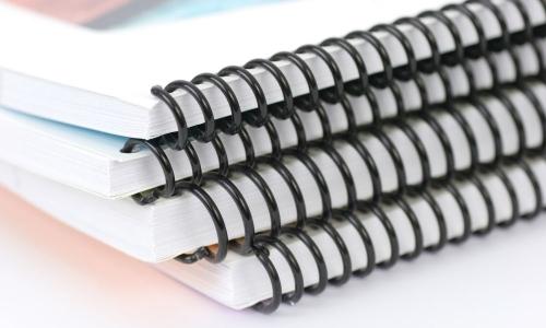Which merits do spiral notebooks offer